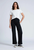 Model wears black high rise wide leg jeans with black sneakers and a short sleeve white t-shirt. 