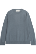 A slate blue crewneck knit sweater with raglan sleeves, laid flat against a solid white background. 