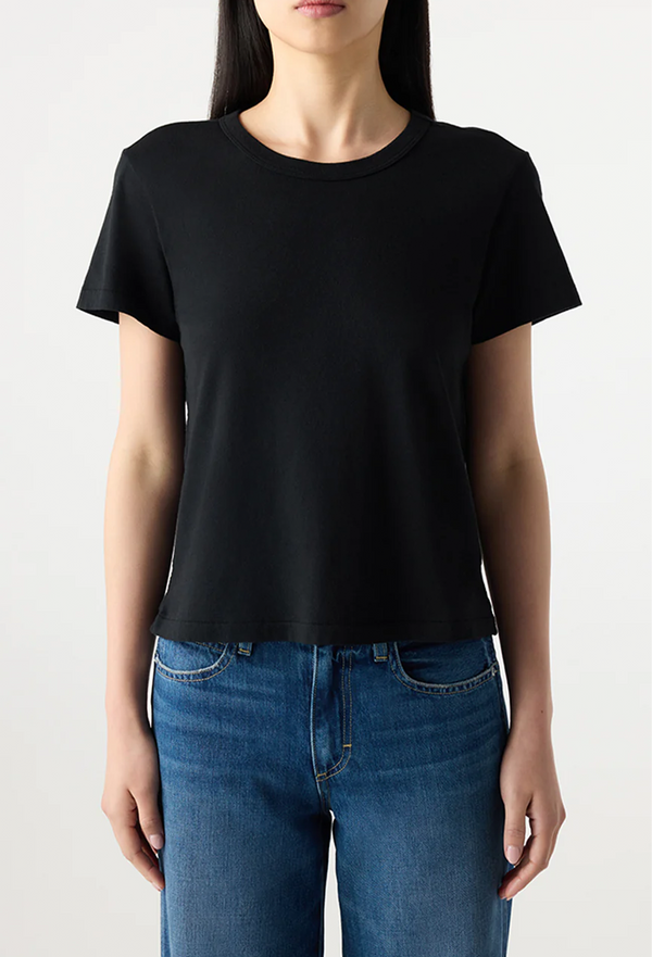 Person wearing a black t-shirt and blue jeans on a plain background
