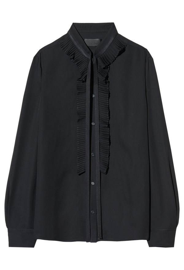 Black blouse with ruffled details on a white background