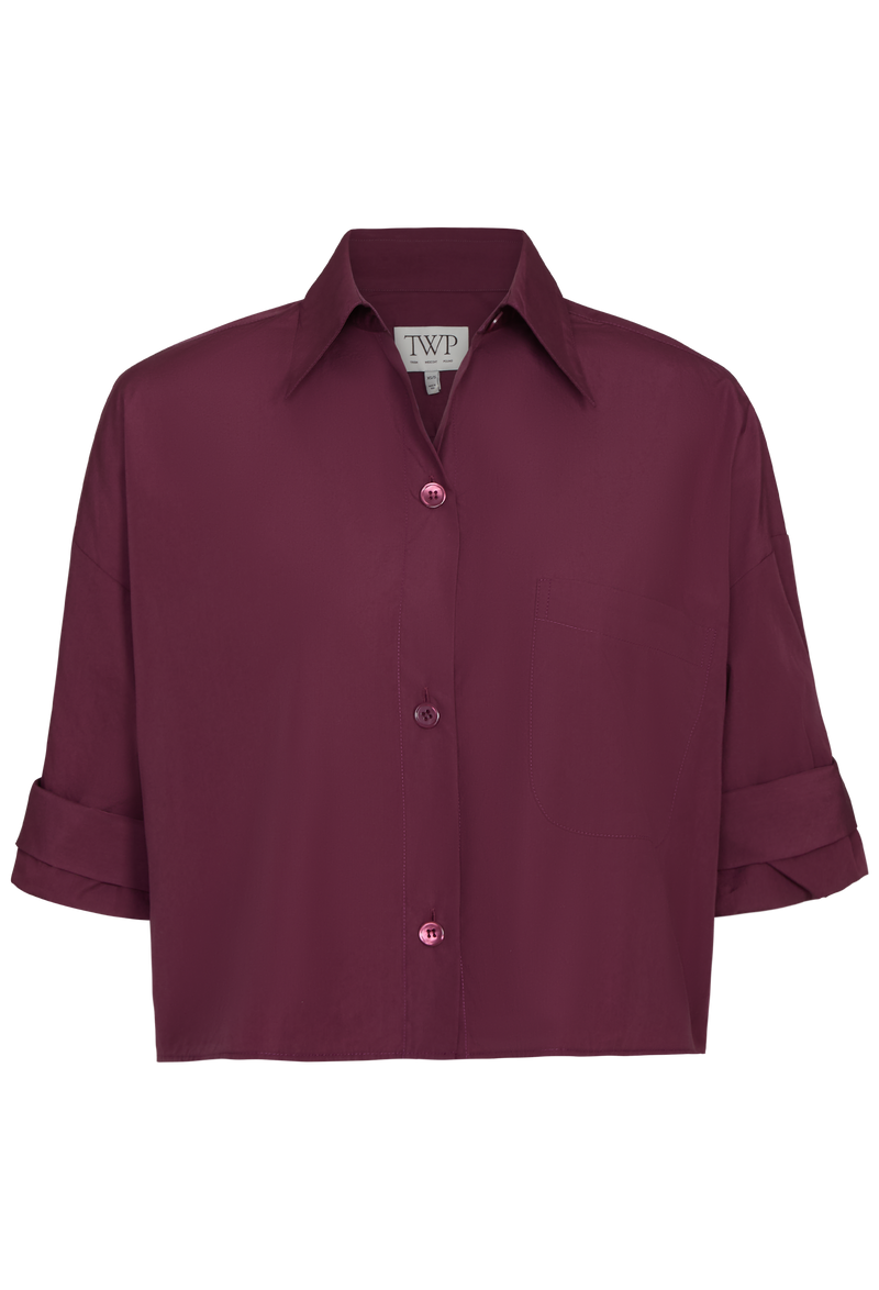 Burgundy shirt with rolled-up sleeves on a white background
