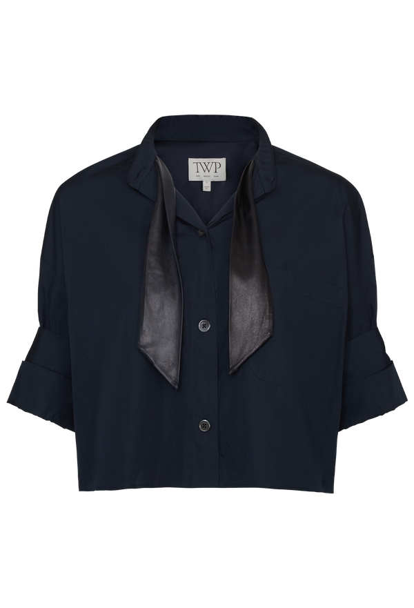 Navy blue blouse with a bow detail on a white background