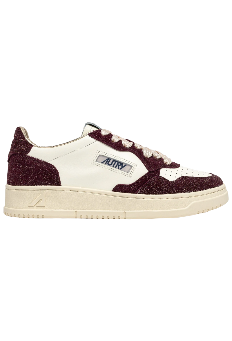 Sneaker with maroon and white design on a white background