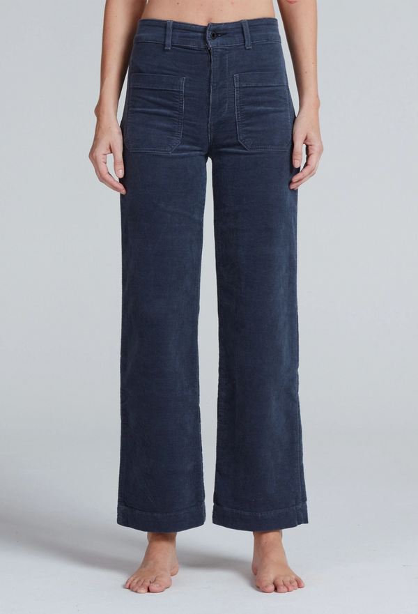 Navy blue wide-leg pants worn by a person on a light gray background