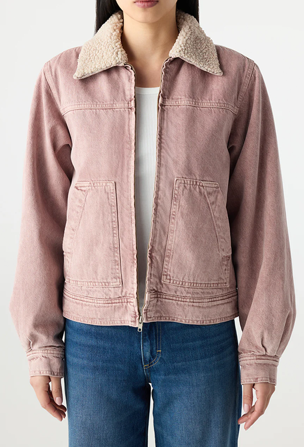 Pink jacket with sherpa lining worn by a person on a white background