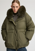 Person wearing a green puffer jacket with a fur-lined hood on a white background