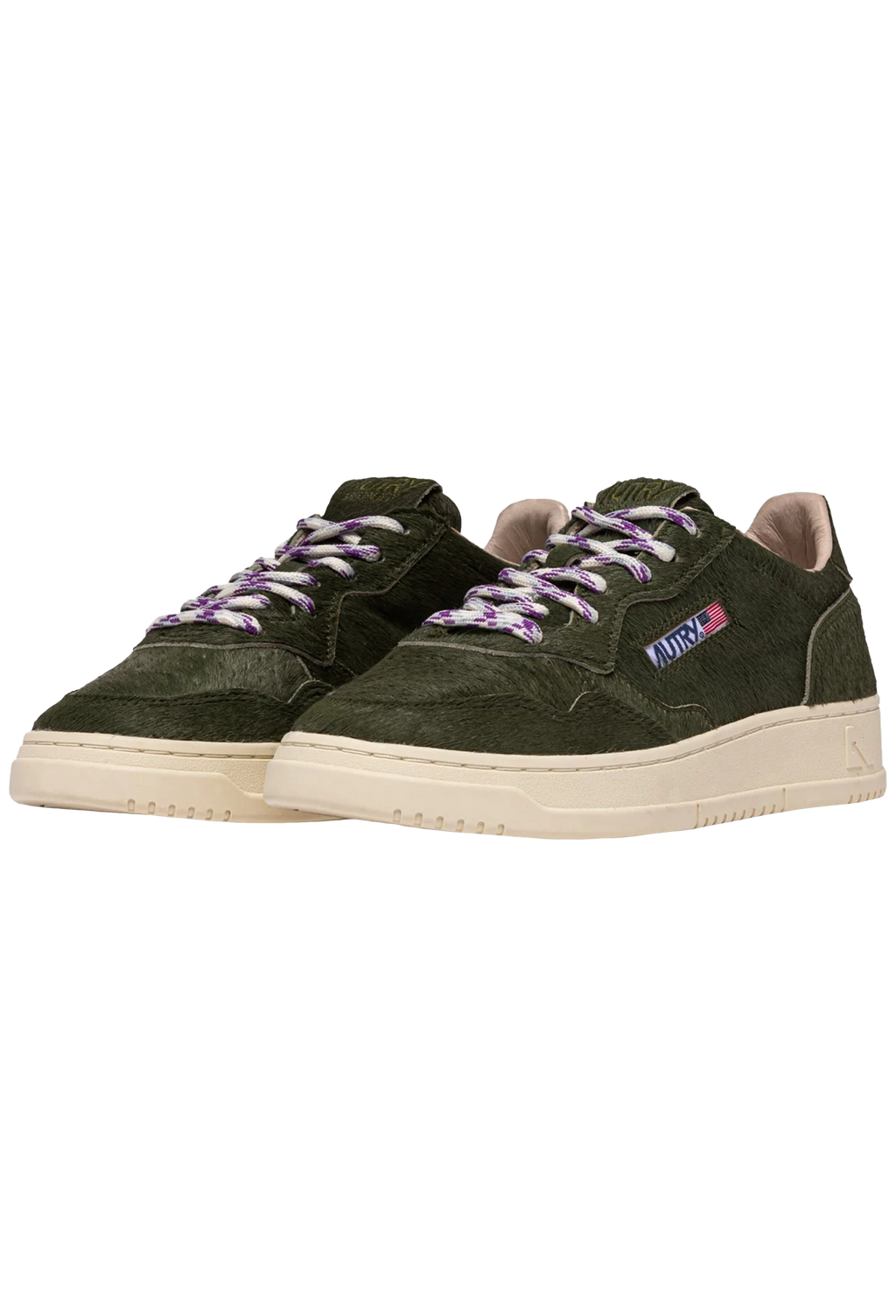 Green sneakers with purple laces on a white background