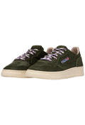 Green sneakers with purple laces on a white background