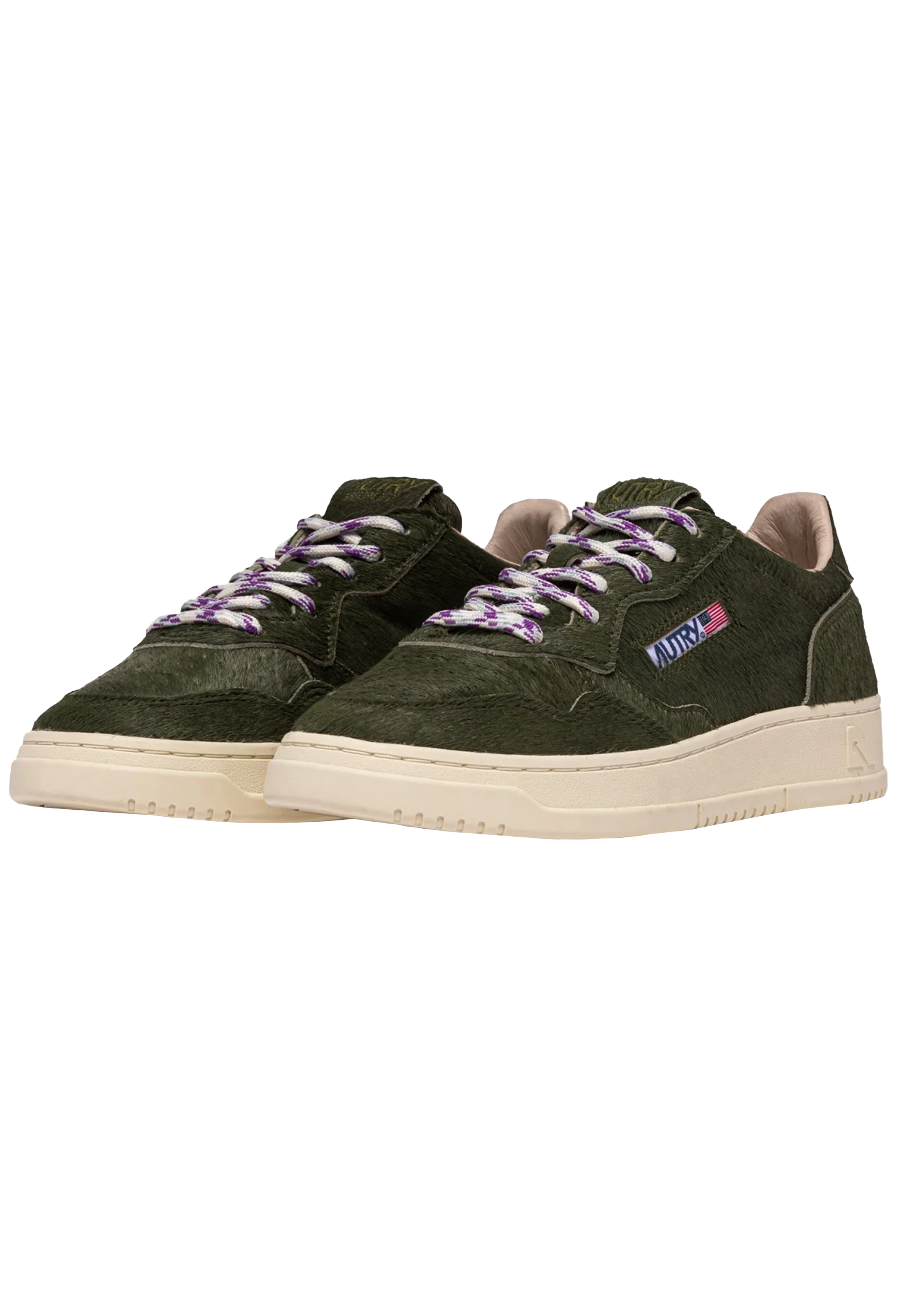 Green sneakers with purple laces on a white background