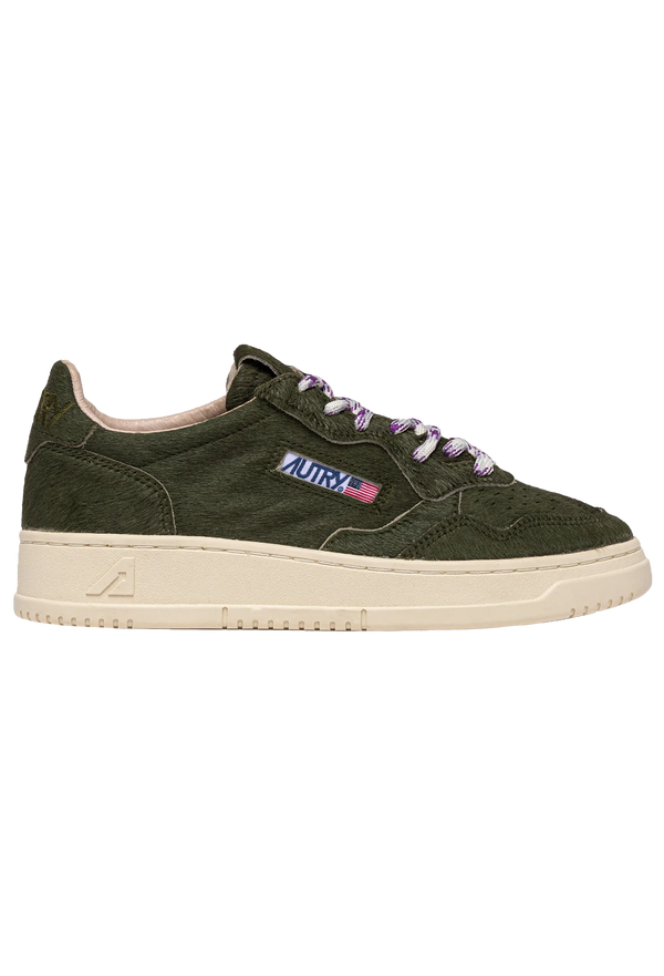 Green sneaker with autry brand logo on a white background