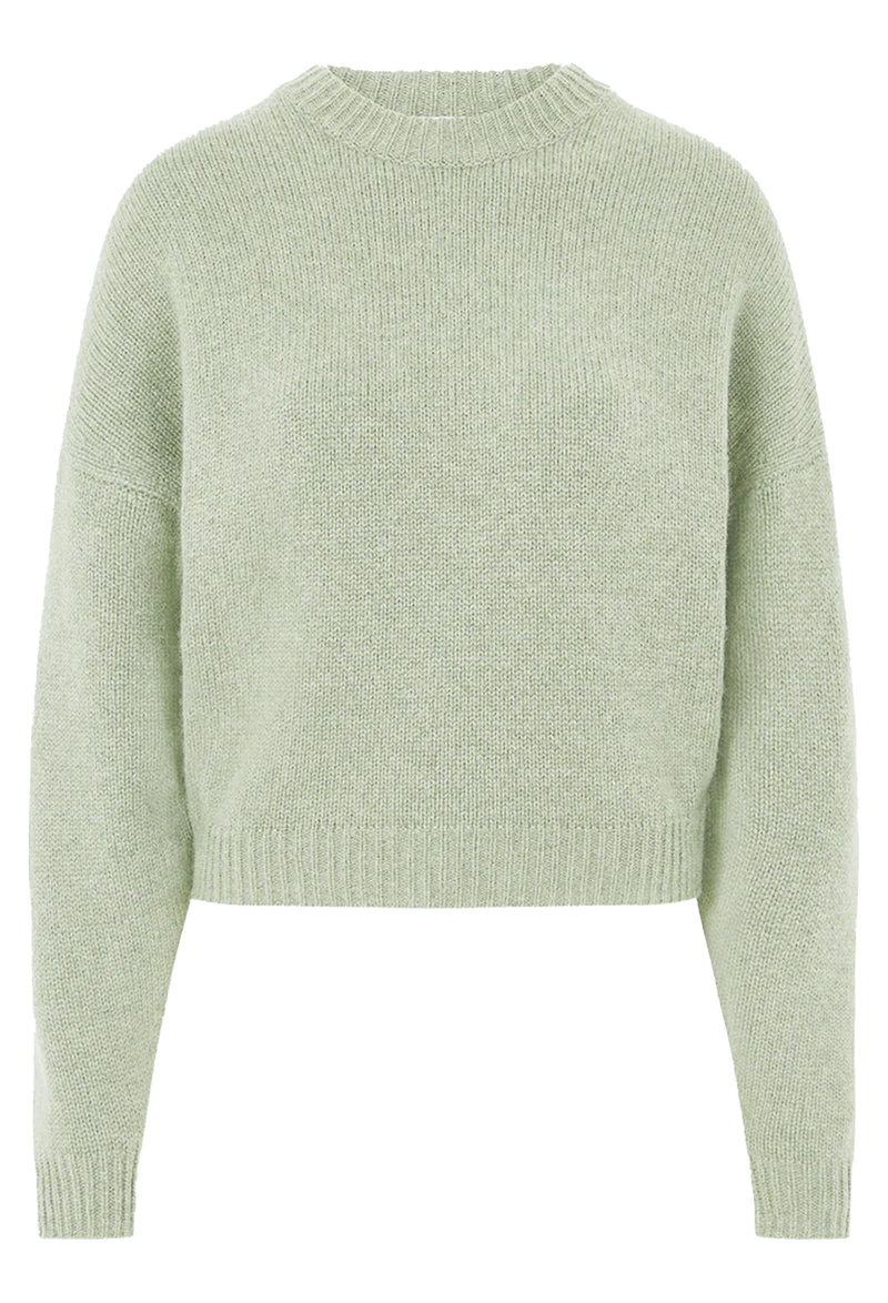 Light green knitted sweater on a white background