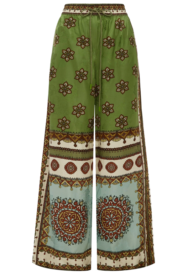 Green patterned pants with a mix of geometric and floral designs on a white background