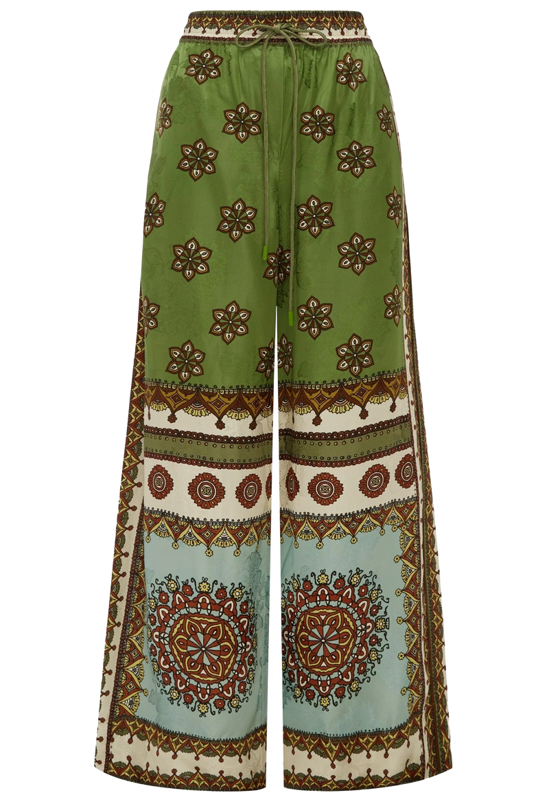 Green patterned pants with a mix of geometric and floral designs on a white background