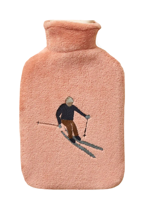 Pink hot water bottle with a skiing design on a white background
