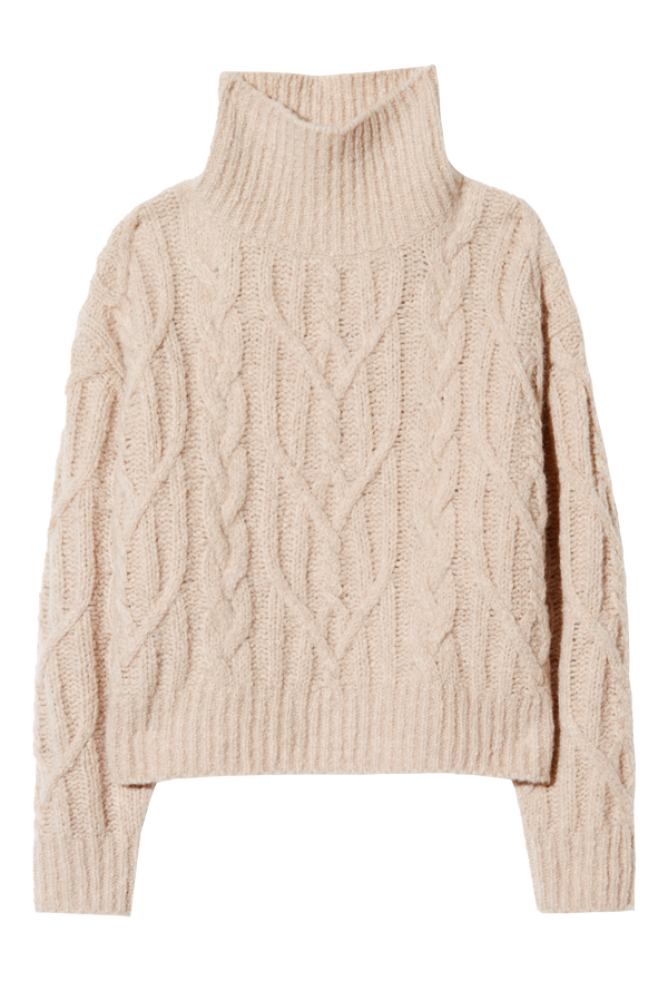 a light beige chunky knit sweater and jeans on a white background