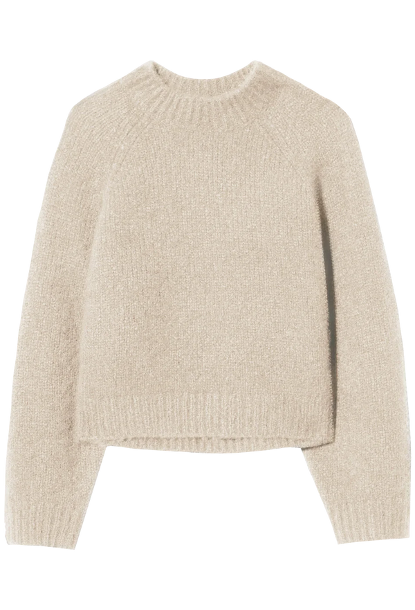 an off white knit sweater on a white background
