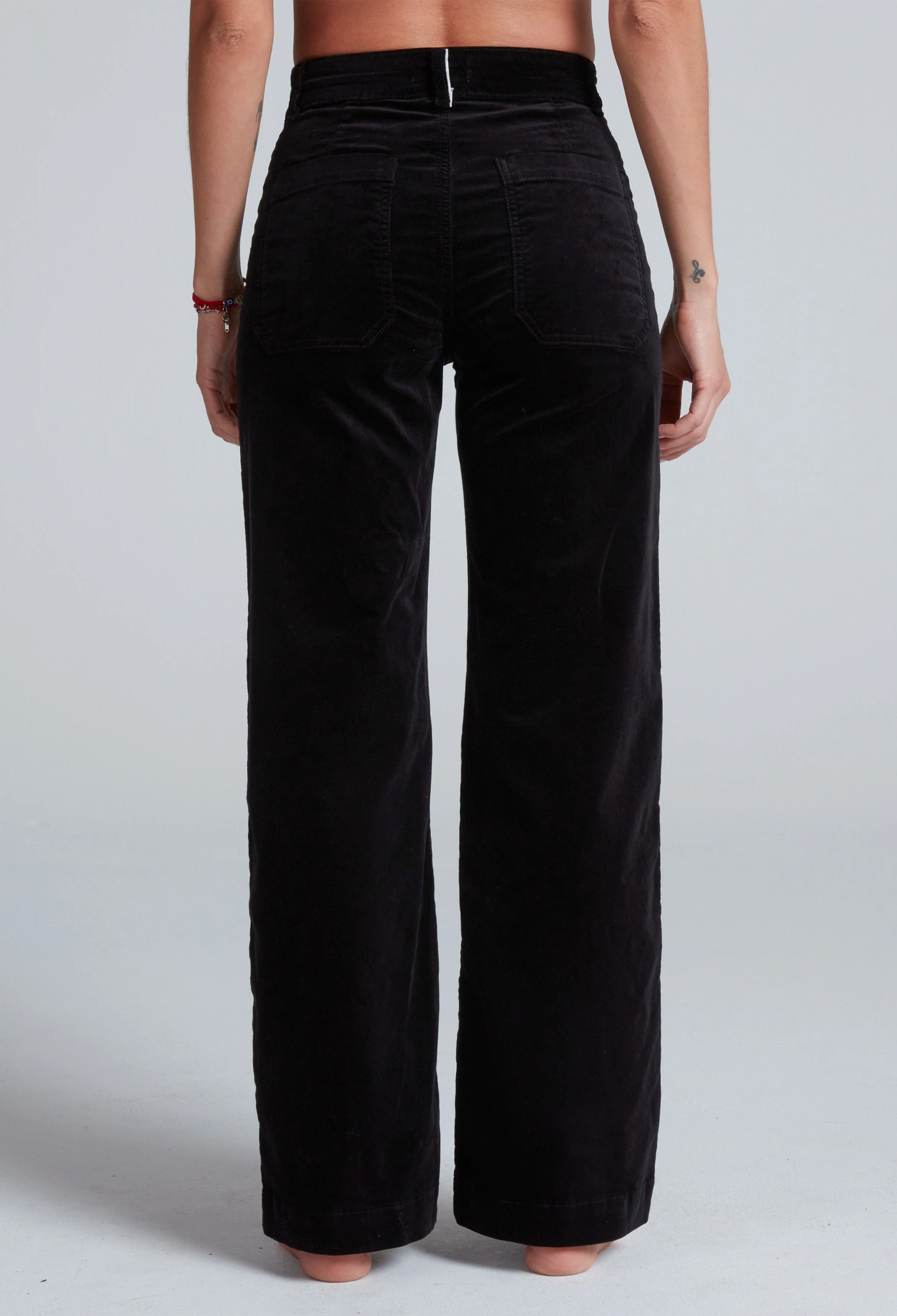 Black wide-leg pants worn by a person on a white background