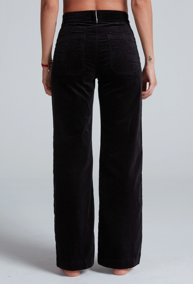 Black wide-leg pants worn by a person on a white background