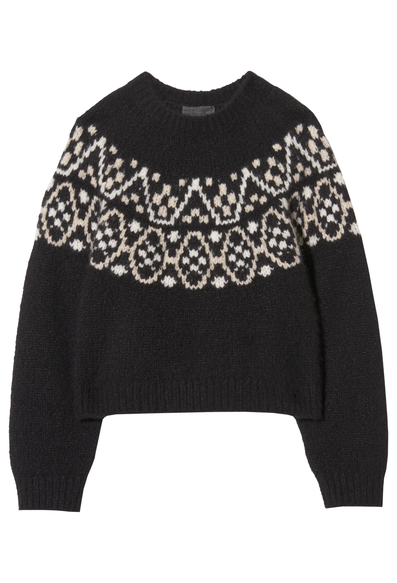 a black sweater with fair isle pattern on a plain background