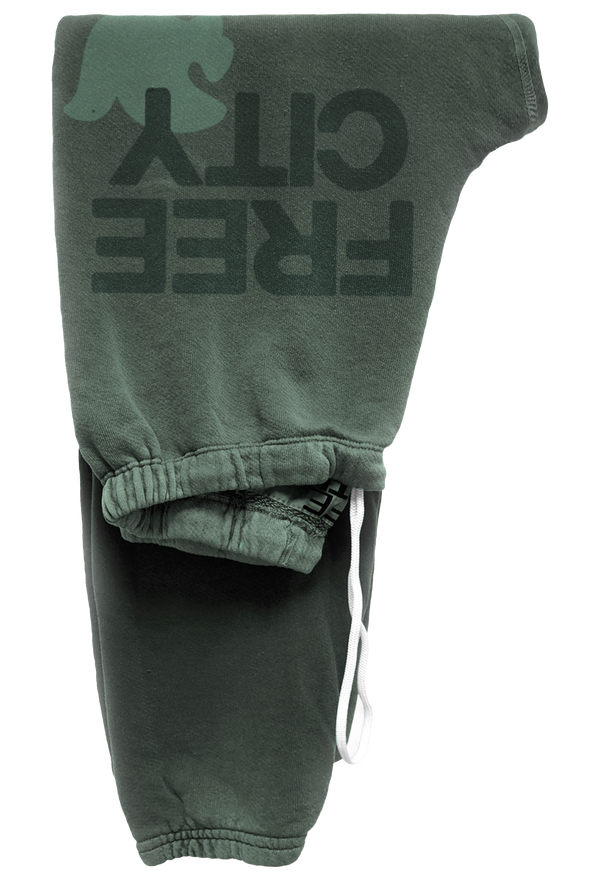 Green sweatpants with 'FREE CITY' text on a white background