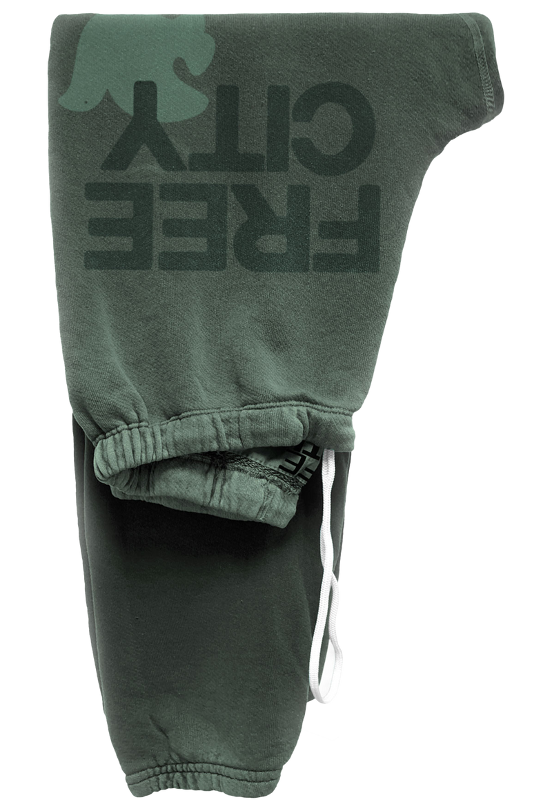 Green sweatpants with 'FREE CITY' text on a white background