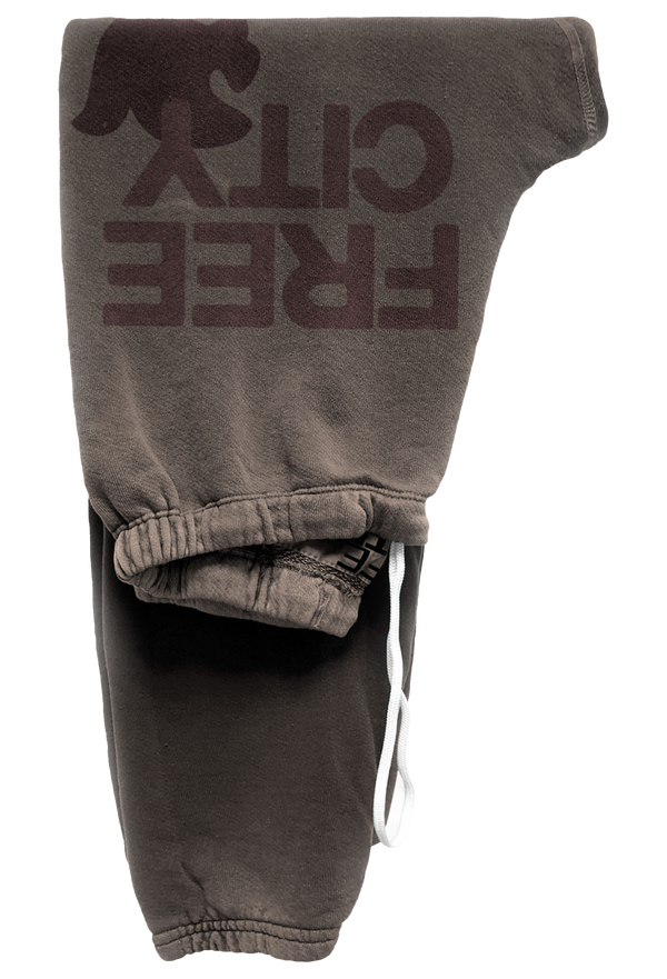 Brown sweatpants with free city text on a white background