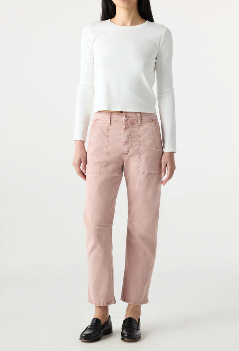 Person wearing a white long-sleeve shirt and pink pants on a white background