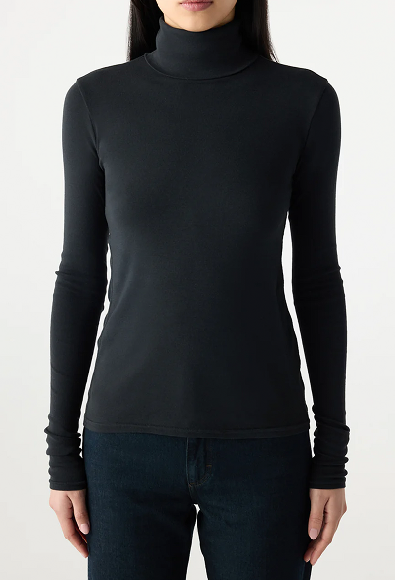 Person wearing a black turtleneck sweater against a white background