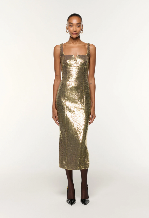 Gold sequin dress worn by a model on a white background