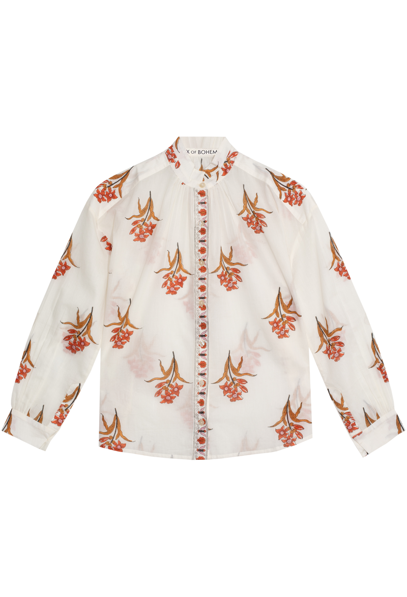White shirt with orange floral pattern on a white background