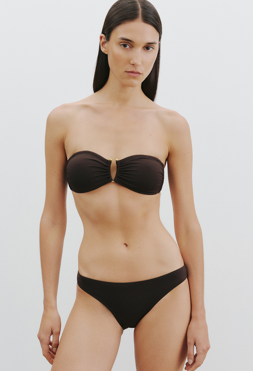 Woman wearing a brown bikini on a white background