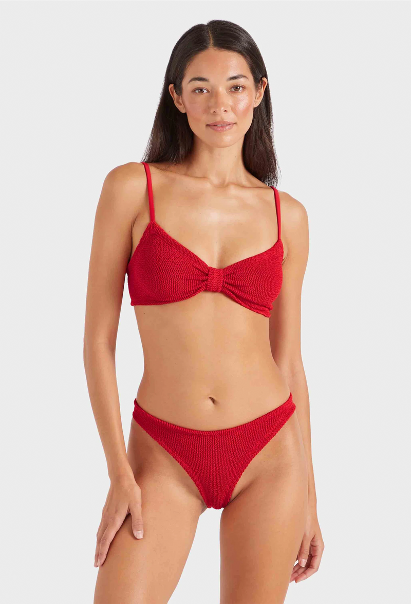 a woman wearing a red bikini on a white background