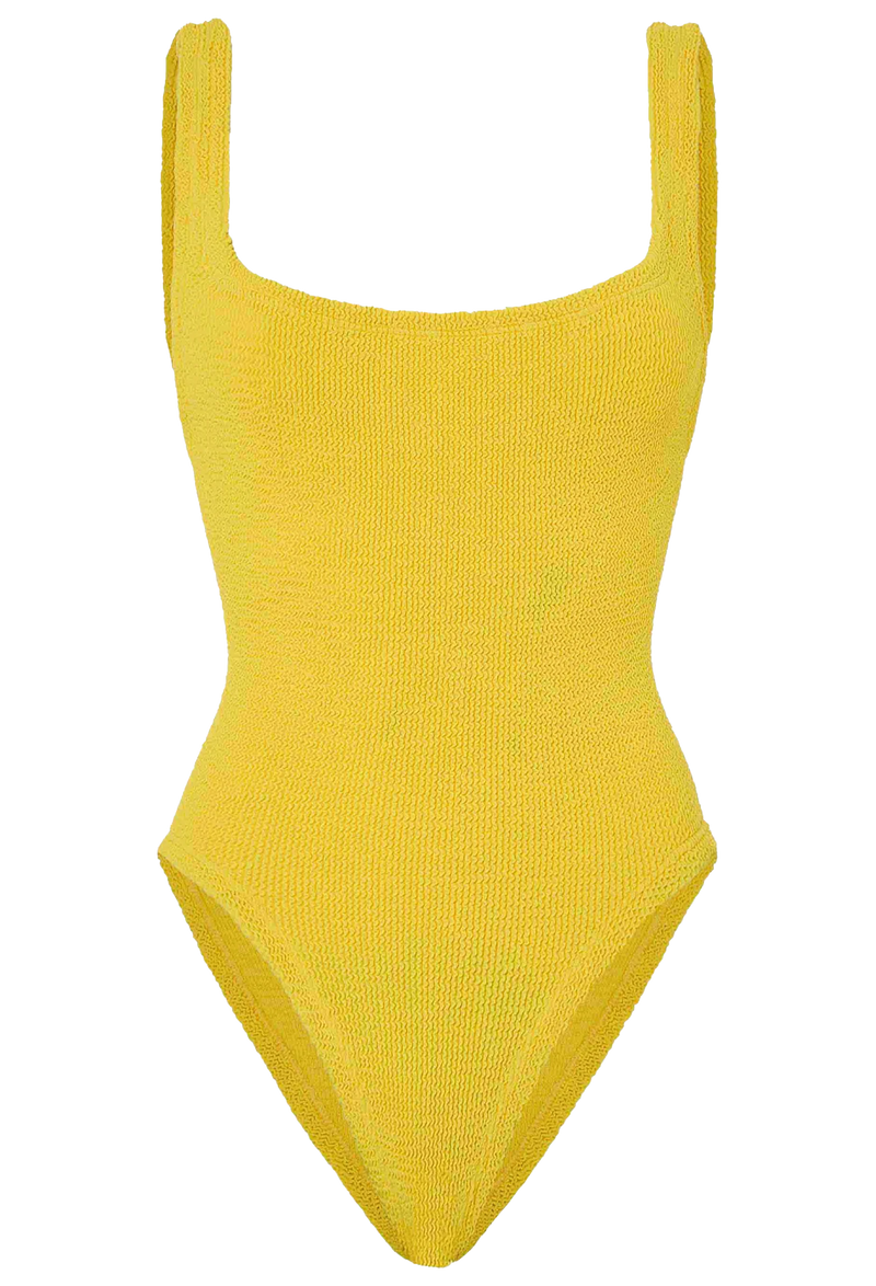 a woman wearing a yellow one piece swimsuit on a white background