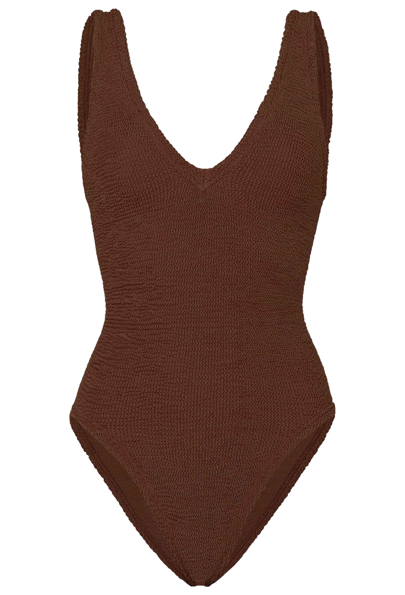 a woman wearing a metallic brown deep V one piece swimsuit on a white background