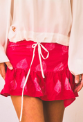 Red skirt with white leaf pattern and drawstring on a plain background