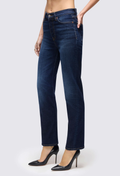 a model wearing dark blue jeans on a white background