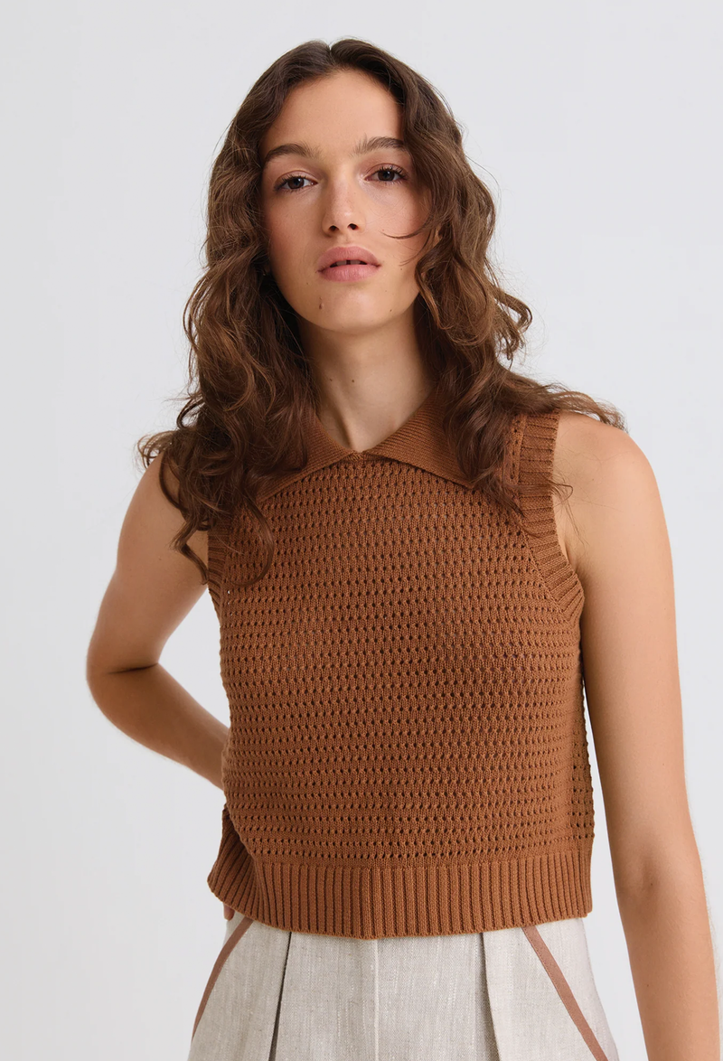 a model wearing a brown mesh knit collared tank top on a white background