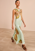 Model wearing a light green dress with blossoms pattern on a neutral background