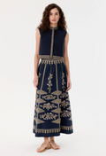 Woman wearing a blue skirt with gold patterns on a white background