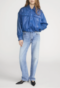Person wearing a blue denim jacket and jeans on a white background