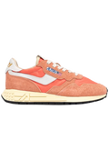 Coral sneaker with white accents on a white background