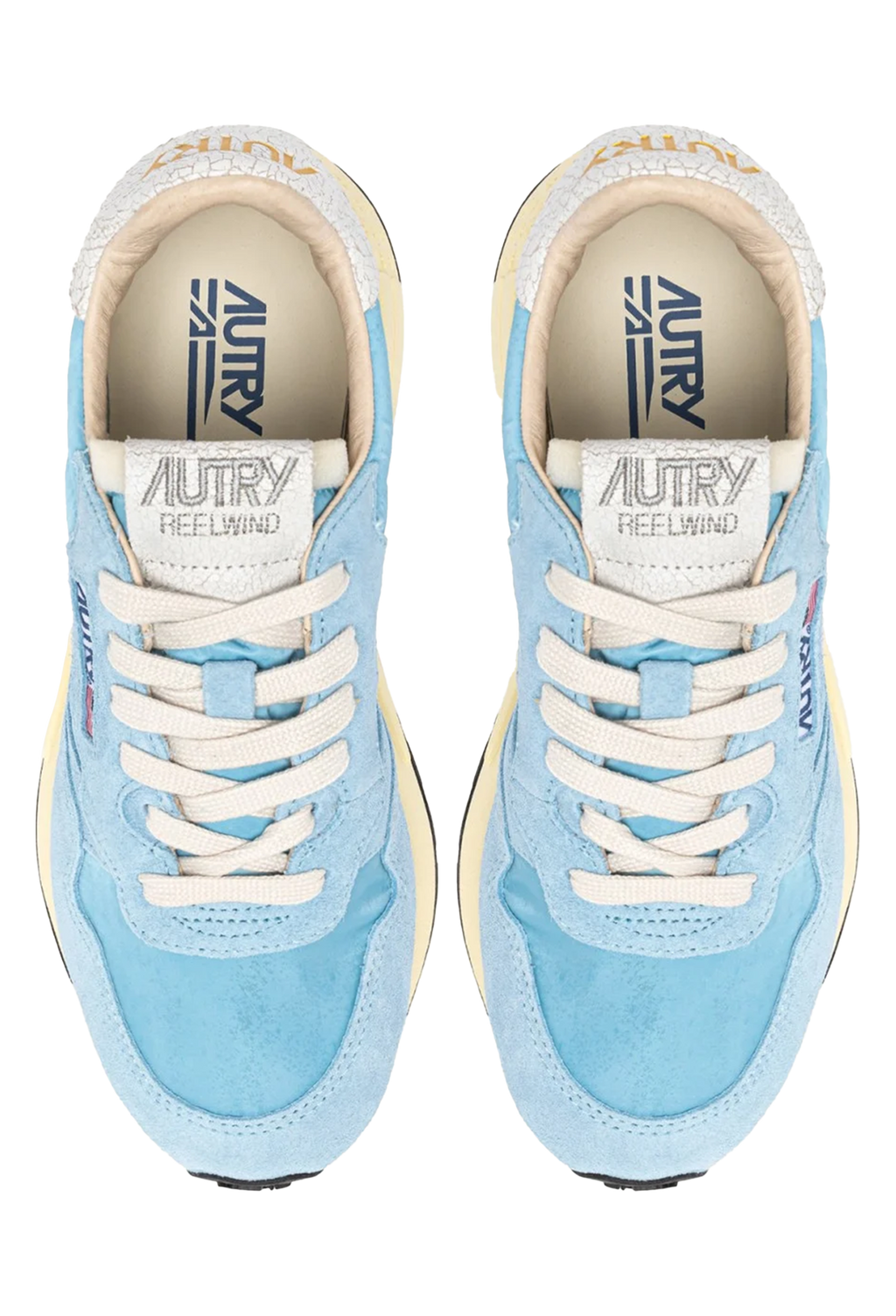 Pair of blue sneakers with white laces on a white background