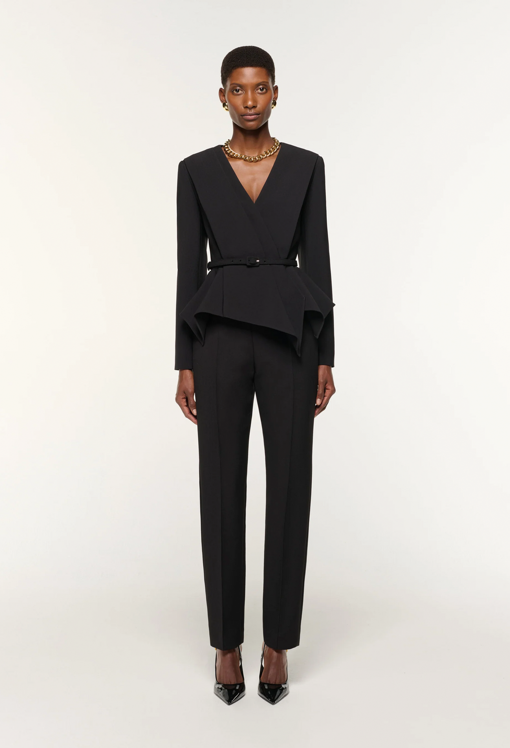 Black suit worn by a model on a white background