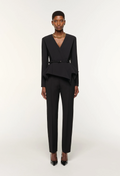 Black suit worn by a model on a white background