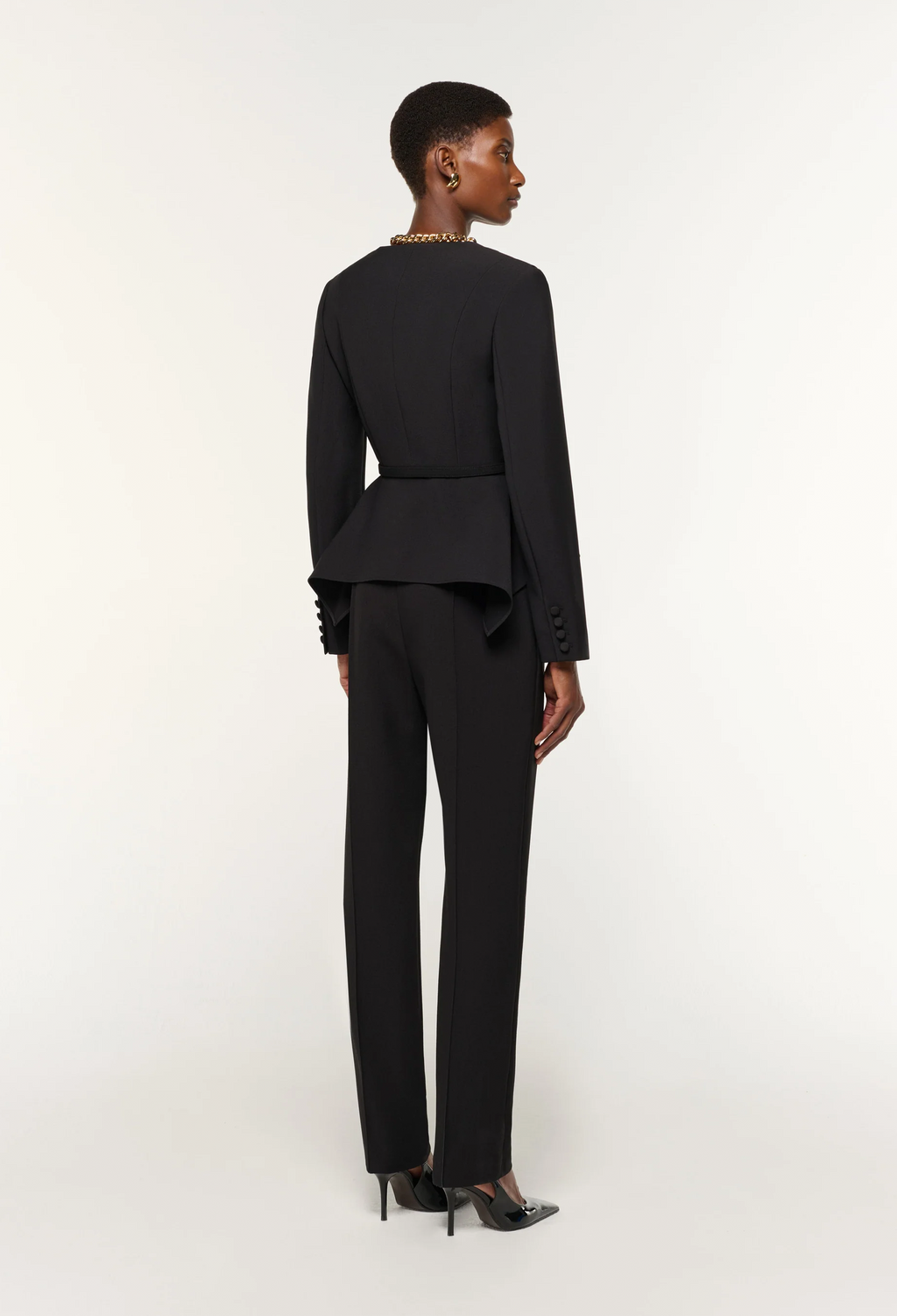 Woman wearing a black suit on a white background