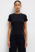 Person wearing a black t-shirt and pants against a white background