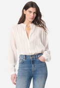 Woman wearing a white blouse and blue jeans on a white background