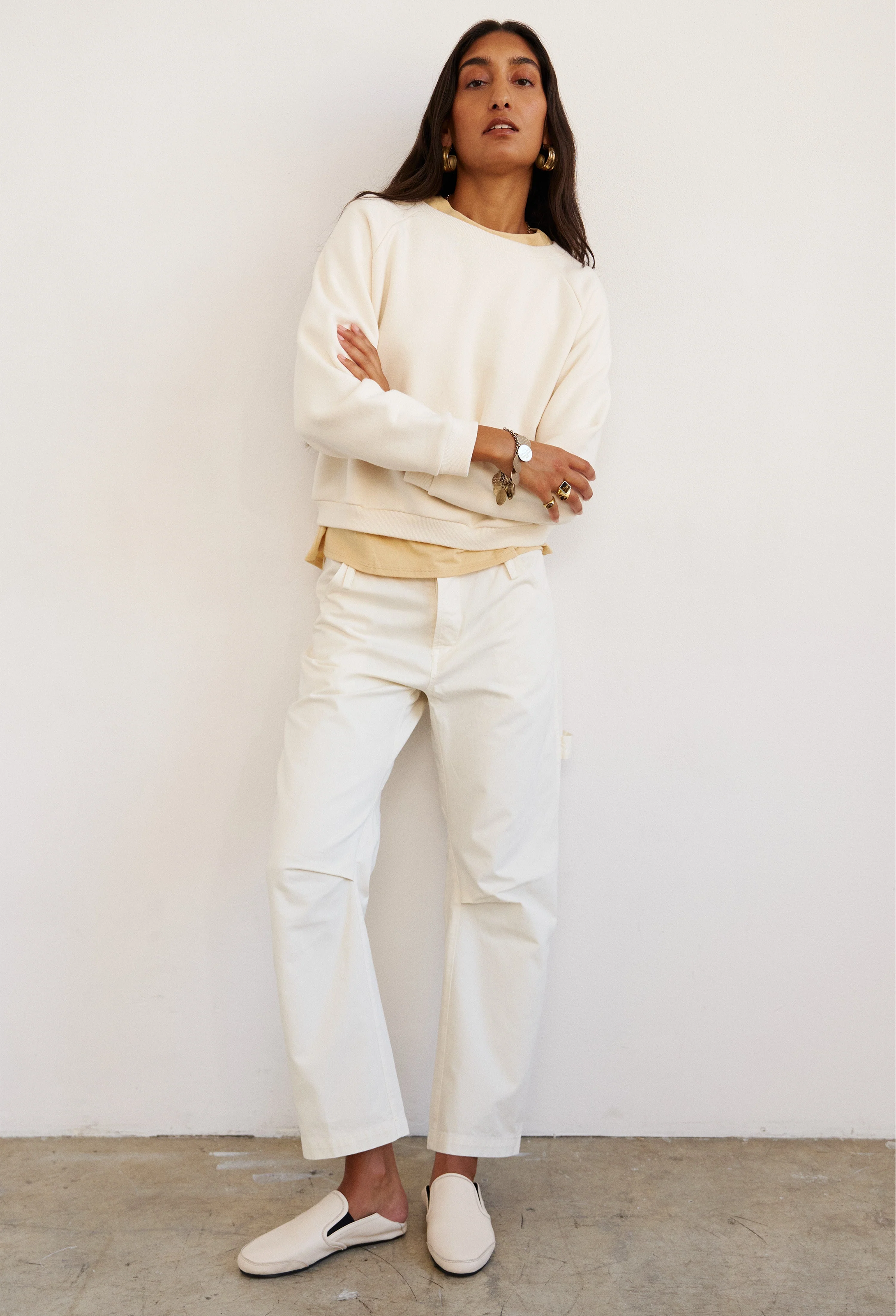 Person wearing a white outfit with a plain background