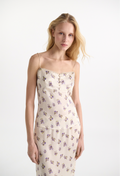 Woman wearing a floral top and skirt on a white background