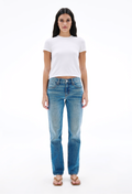 Woman wearing a white t-shirt and blue jeans on a white background